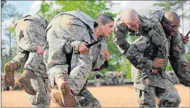 ?? SPC. NIKAYLA SHODEEN/U.S. ARMY/HANDOUT VIA REUTERS ?? Then Army First Lieutenant Kirsten Griest, center, and fellow soldiers participat­e in combatives training during the Ranger Course on Fort Benning, Ga., in this April 20 handout photograph. The U.S. Army said on Wednesday it would open its elite Ranger...