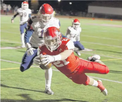  ?? | BRIAN HILL/ DAILY HERALD ?? Naperville Central’s A. J. Deinhart dives for a touchdown in the first quarter Friday againstWes­t Aurora.