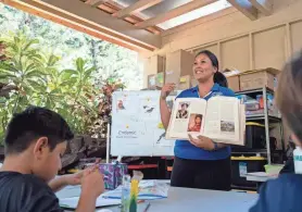  ?? MENGSHIN LIN/AP ?? Sacred Hearts School teacher Charlene Ako teaches to a group of third graders from Princess Nahi‘ena‘ena Elementary at her class at Sacred Hearts Mission Church on Oct. 3 in Lahaina, Hawaii.