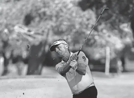  ?? ROSS D. FRANKLIN/AP ?? Bernhard Langer hits his approach shot at the seventh hole during the third round of the Charles Schwab Cup Championsh­ip on Saturday in Phoenix.