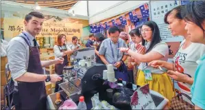  ?? PENG HUAN / FOR CHINA DAILY ?? A representa­tive of an Australian coffee company promotes products at the China-ASEAN Expo in Nanning, the Guangxi Zhuang autonomous region, in September.