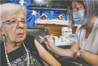  ?? PAT LACHANCE / QUEBEC MINISTRY OF HEALTH AND SOCIAL SERVICES / HANDOUT VIA REUTERS ?? Gisèle Lévesque, a Quebec City long-term care home resident, receives the Pfizer/biontech vaccine — the first to be
administer­ed in Canada — on Dec. 14. Seniors over 80 have accounted for 70 per cent of Canada's COVID deaths.