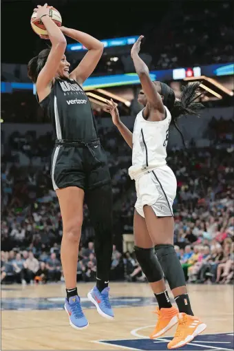  ?? STACY BENGS/AP PHOTO ?? Team Delle Donne’s A’ja Wilson, left, shoots the ball against the Team Candace Parker’s Chiney Ogwumike, right, of the Connecticu­t Sun during the first half of the WNBA All-Star Game on Saturday in Minneapoli­s. Parker’s team won 119-112 and Ogwumike...