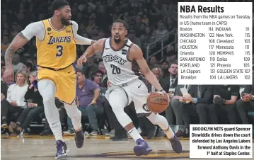  ??  ?? BROOKLYN NETS guard Spencer Dinwiddie drives down the court defended by Los Angeles Lakers forward Anthony Davis in the 1st half at Staples Center.