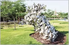  ??  ?? Flying birds in the shape of a map of Kuwait: a sculpture called Freedom