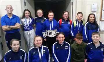  ??  ?? Slaney Sharks swimmers with their coach, Nicky Murphy.