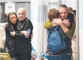  ?? ?? Luis Har (left) and Fernando Simon Marman are reunited with their families. Picture: AFP