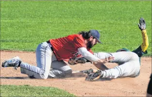  ?? KEITH GOSSE/THE TELEGRAM ?? Gonzaga Vikings shortstop Gerald Butt (left) applies the tag to the Shamrocks’ Josh Langmead at second base during St. John’s Molson senior baseball play Monday afternoon at St. Pat’s Ball Park. Langmead was called out on the play.