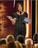  ?? MICHAEL LOCCISANO/ GETTY IMAGES ?? Singersong­writer Keith Urban accepts his award Nov. 14 during the 52nd annual CMA Awards in Nashville, Tenn.