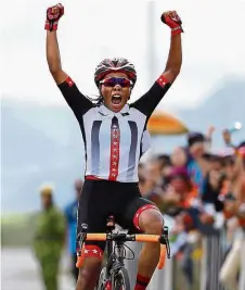  ??  ?? Winner’s joy: erengganu s Nur Aisyah u ir cele rates after crossing the finish line to in the
omen s m road race yesterday