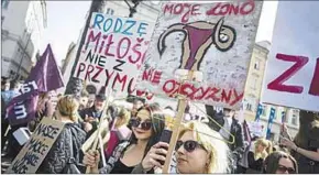  ??  ?? Stakende vrouwen gekleed in het zwart zwaaiden met zwarte vlaggen. Ze staken kleerhange­rs op als symbool voor illegale abortussen. (oneworld.nl)