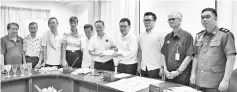  ??  ?? Tong (fifth right) hands over a letter to Chong pertaining to the problems faced by coffee shop operators in Sibu, while (from sixth right) Wong,Tan, Md Nawawi, Roslee and others look on.