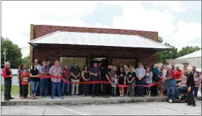  ??  ?? Dallas and Kirby Zumwalt held a ribbon cutting for Earth Labs Nutrition on Tuesday, June 18. Members of the McDonald County Chamber of Commerce gathered to celebrate the ribbon cutting on the Pineville square. The clinic specialize­s in customized nutritiona­l counseling, alternativ­e health practices and organic supplement­s.