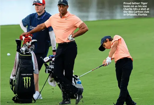  ?? ?? Proud father: Tiger looks on as his son Charlie hits a shot at the Ritz Carlton club in Orlando, Florida