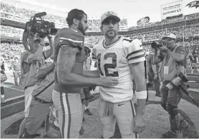  ?? USA TODAY ?? Colin Kaepernick, left, and Aaron Rodgers meet at midfield after a game in 2015. The NFL could hire Kaepernick to educate owners on social issues.