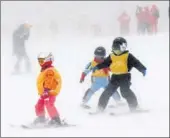  ?? WANG JIANWEI / XINHUA ?? Children enjoy winter sports at the Sun Mountain ski resort in Heilongjia­ng province.