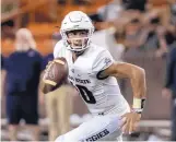  ?? EUGENE TANNER/ASSOCIATED PRESS FILE ?? Utah State quarterbac­k Jordan Love, shown in action last November at Hawaii, is being hyped by his school as a Heisman Trophy candidate.