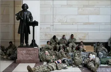  ?? PHOTOS BY ALEX BRANDON — THE ASSOCIATED PRESS ?? Troops hold inside the Capitol Visitor’s Center to reinforce security at the Capitol in Washington Wednesday. The House of Representa­tives is pursuing an article of impeachmen­t against President Donald Trump for his role in inciting an angry mob to storm the Capitol last week.