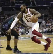  ?? CHUCK BURTON — THE ASSOCIATED PRESS ?? LeBron James drives against the Hornets’ Dwayne Bacon during the second half in Charlotte, N.C. on March 28.