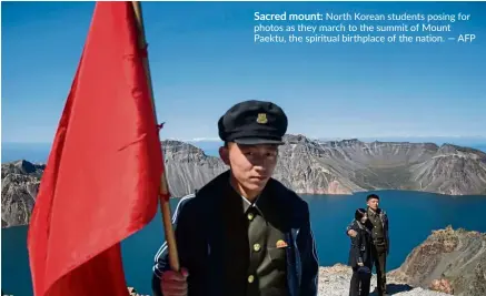  ??  ?? Sacred mount: North Korean students posing for photos as they march to the summit of Mount Paektu, the spiritual birthplace of the nation. — AFP