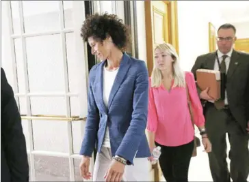  ?? DAVID MAIALETTI/POOL/AFP ?? Andrea Constand (centre) leaves the courtroom during a lunch break in the Montgomery County Courthouse in Norristown, Pennsylvan­ia, on Monday.