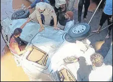  ?? ANI ?? Rescuers pulling out the car that fell into a swollen rivulet near Ramnagar in Udhampur on Wednesday.