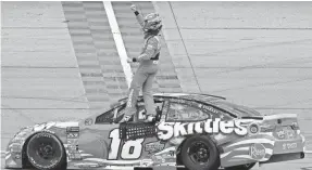  ??  ?? NASCAR driver Kyle Busch celebrates after winning the Overton’s 400 at Chicagolan­d Speedway on Sunday in Joliet, Ill.