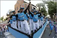  ?? GENE J. PUSKAR — THE ASSOCIATED PRESS ?? The Caribbean Region Champion Little League team from Willemstad, Curacao, rides in the Little League Grand Slam Parade in downtown Williamspo­rt, Pa., Wednesday. The Little League World Series baseball tournament, featuring 16 teams from around the world, starts in South Williamspo­rt, Pa.