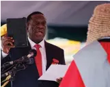  ??  ?? Above: Emmerson Mnangagwa and his wife Auxillia arrive at the Zimbabwe presidenti­al inaugurati­on ceremony in the capital Harare.
Left, Mr Mnangagwa is sworn in. Photos: AP/Ben Curtis