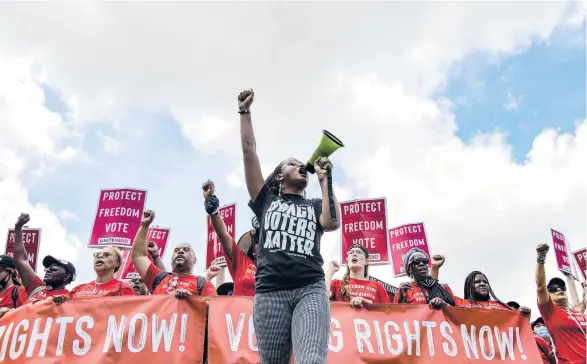  ?? KENNY HOLSTON/THE NEW YORK TIMES ?? Voting rights activists march Saturday on the National Mall in Washington. The Supreme Court’s 6-3 ruling Thursday will likely help Republican states fight challenges to voting restrictio­ns being put in place.