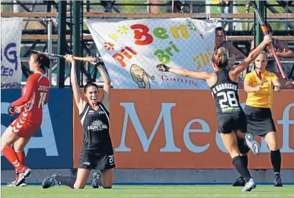  ??  ?? Enjoying the moment: Black Sticks Cathryn Finlayson, left, and Charlotte Harrison celebrate after Finlayson scored against South Korea in their