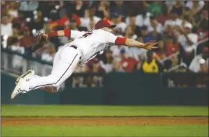  ?? The Associated Press ?? MAKING THE THROW: Washington Nationals second baseman Brian Dozier throws a ground ball single by Atlanta Braves’ Josh Donaldson to first base in the sixth inning of Monday’s game in Washington.