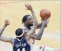  ?? Gerald Herbert / Associated Press ?? Julius Randle of the Knicks drives against the Pelicans’ Brandon Ingram. Randle was 5-for-8 from 3-point range.