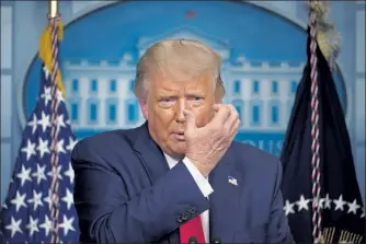  ?? MANDEL NGAN / GETTY IMAGES ?? President Donald Trump gestures as he speaks about face masks during a press conference Wednesday at the White House.