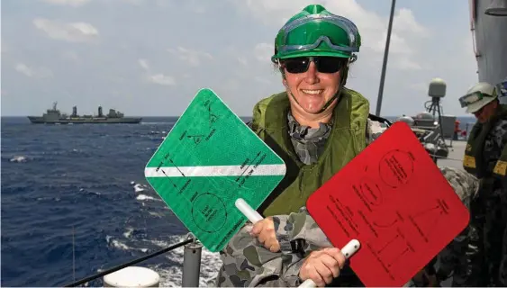  ?? Photo: ABIS Steven Thomson ?? AT SEA: Petty Officer Maritime Logistics - Personnel Lauren Birch on HMAS Toowoomba’s gun direction platform on completion of a replenishm­ent at sea with HMAS Success during South East Asia deployment in 2018.