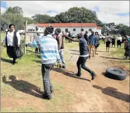  ?? Picture: LULAMILE FENI ?? GRIEVANCES: Tensions flared between feuding factions of the Presbyteri­an Church of Southern Africa in Ross Mission on Sunday. The church gates were barricaded with burning tyres