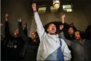  ?? MICHAEL M. SANTIAGO ?? Christian Carter, of Pittsburgh’s East Liberty neighborho­od, left, leads a chant with other supporters of Antwon Rose II after they learned a not guilty verdict in the homicide trial of former East Pittsburgh police Officer Michael Rosfeld, Friday, March 22, 2019, at the Allegheny County Courthouse in downtown Pittsburgh, Pa. A jury acquitted Rosfeld, a former police officer Friday in the fatal shooting of Antwon Rose II, an unarmed teenager as he was fleeing a high-stakes traffic stop outside Pittsburgh, a confrontat­ion that was captured on video and led to weeks of unrest. (Michael M. Santiago/Pittsburgh Post-Gazette via AP)