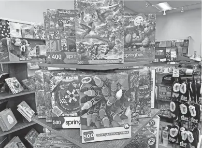  ?? PHOTOS BY DAVID P. WILLIS/ASBURY PARK PRESS ?? Puzzles and toys are for sale at Norman’s Hallmark in the Seaview Square shopping center in Ocean Township.