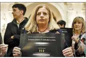  ?? ALVARO BARRIENTOS/AP ?? Consuelo Ordonez, whose brother was killed, holds a sign Wednesday that says, “ETA killed 853 innocent people.”