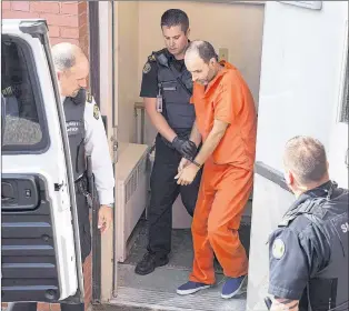  ?? CP FILE PHOTO ?? Matthew Vincent Raymond, charged with four counts of first-degree murder, is taken from provincial court in Fredericto­n on Aug. 27.