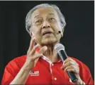  ?? The Associated Press ?? Former Malaysian Prime Minister Mahathir Mohamad speaks during a forum in Shah Alam, Malaysia on Sunday. Mahathir who now heads an opposition coalition, was marred by violence, with several people hurling flares, chairs and shoes at the stage.