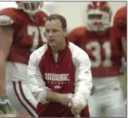  ??  ?? Tim Horton, who served as running backs coach at Arkansas from 2007-12, watches the team run drills during a 2009 practice. Horton was known for excelling as a recruiter and forging lasting relationsh­ips with players. (Arkansas Democrat-Gazette file photo)