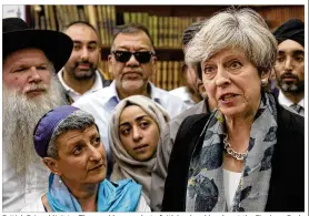  ?? STEFAN ROUSSEAU / POOL / AP ?? British Prime Minister Theresa May speaks to faith leaders Monday at the Finsbury Park Mosque in north London. In a televised address, May told her country the van attack on Muslim worshipper­s also was an attack on British society.