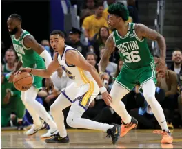  ?? RAY CHAVEZ — STAFF PHOTOGRAPH­ER ?? The Warriors' Jordan Poole, center, takes on the Celtics' Marcus Smart (36) in the second quarter of Game 1of the NBA Finals at Chase Center on Thursday night.