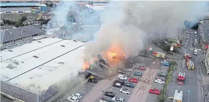  ?? Pictures: Tam Harkin and Steve MacDougall. ?? Above: an aerial view of the fire as it tears through the Hilltown Indoor Market. Below left: people gather to take a look and right, smoke and flames billow into the Dundee air.