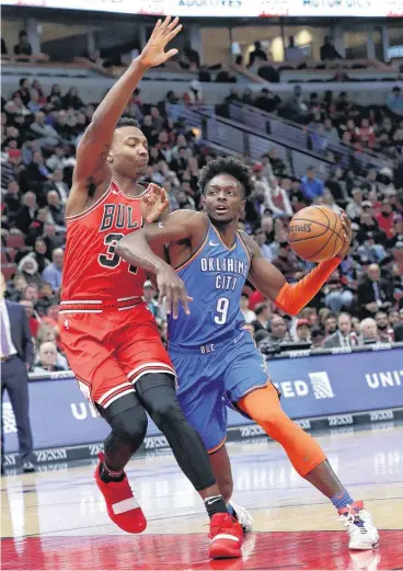  ?? [AP PHOTO] ?? Oklahoma City Thunder forward Jerami Grant, right, drives as Chicago Bulls center Wendell Carter Jr. defends during Friday’s basketball game in Chicago.