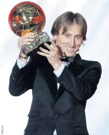  ??  ?? Real Madrid’s Luka Modric celebrates with the Ballon d’Or trophy.