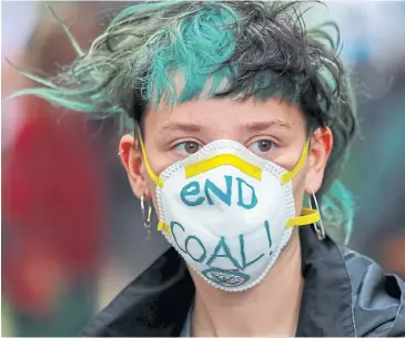  ?? REUTERS ?? An activist attends a protest on July 1 this year in front of Germany’s Social Democratic Party headquarte­rs in Berlin demanding the immediate phase-out of hard coal-powered plants.