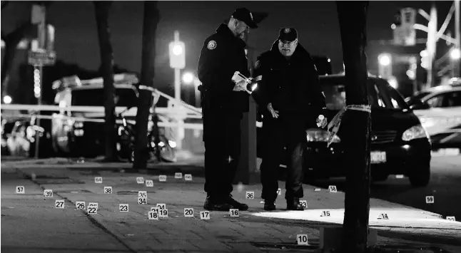  ?? Photo by Andrew Colins for the Toronto Sun ?? Toronto Police assess the scene of a shooting on Eglinton Ave. W. near Keele St. Saturday night. A shooting outside a baby shower inexplicab­ly ended with four male guests and a pregnant woman taken to hospital.