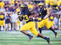  ?? AP FILE ?? Michigan running back O’Maury Samuels was dismissed from the team Wednesday after he was charged with domestic violence. Samuels was a standout at Los Lunas High School.